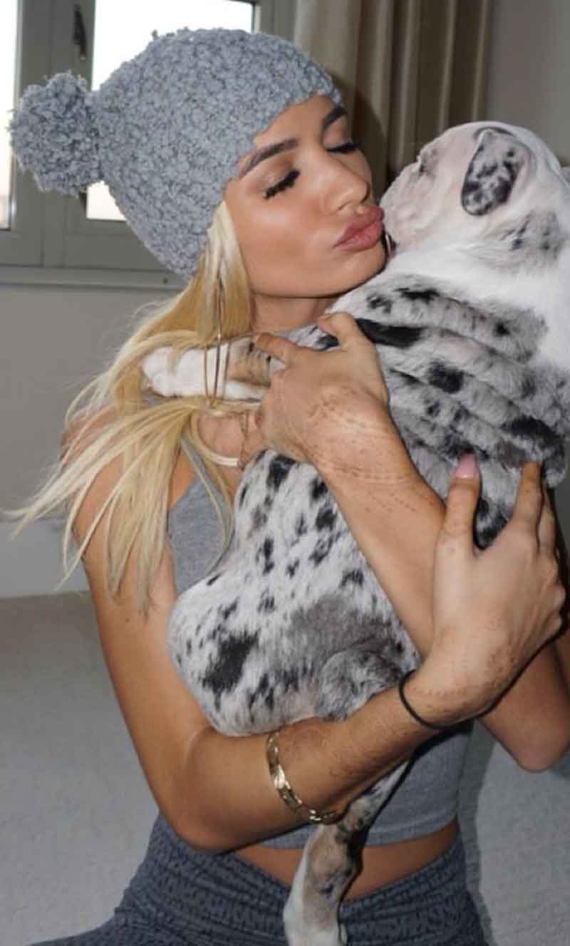 Singer Pia Mia exchanging kisses with her cute, wrinkly, Shrinkabulls mini bully